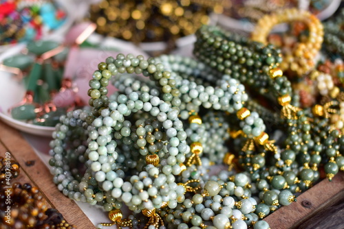 Stone and jade jewelry Beautiful traditional Mon designs at Mon Market, Sangkhlaburi District, Kanchanaburi Province, Thailand © tharathip