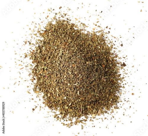 Dried and chopped basil spice pile isolated on white background, top view