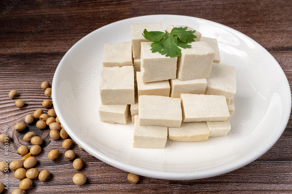 fresh diced tofu in white dish with soy bean. full depth of field. vegan food concept. Healthy eating