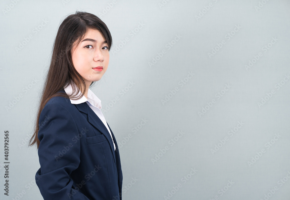 Portrait of asian business woman standing on gray Portrait of asian business woman standing on gray