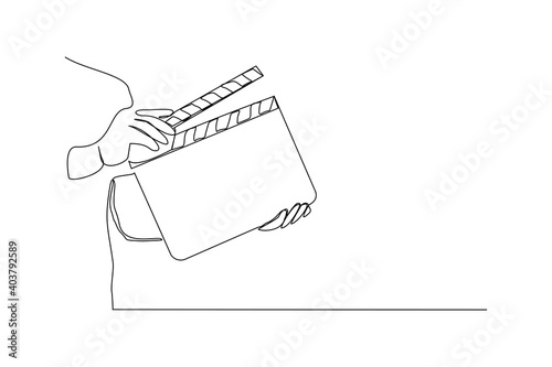 Continuous line drawing of hand hold retro old classic movie board clapper. Vintage film scene taker item concept single one line art design graphic vector illustration