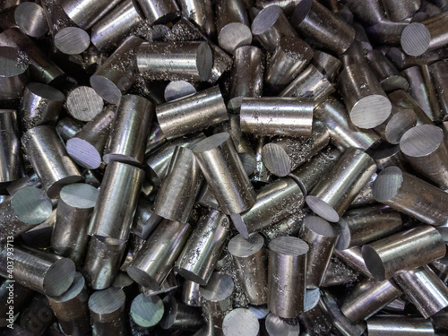 a pile of sawed stainless steel rod chunks - full frame close-up industrial background