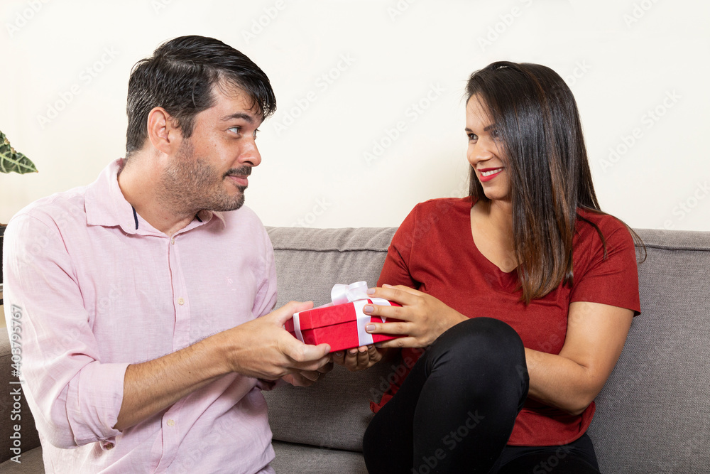 Man doing suspense to deliver present to his wife. Man doing suspense to deliver present to his wife.