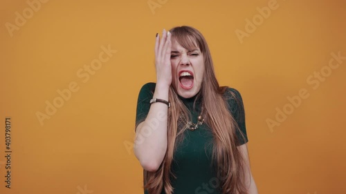 Covering eyes with hand but peeking through fingers. My eye see everything. Studio shot of sincere pretty caucasian, I can not hold promise. Charming playful. Wanting to distinguish surprise.