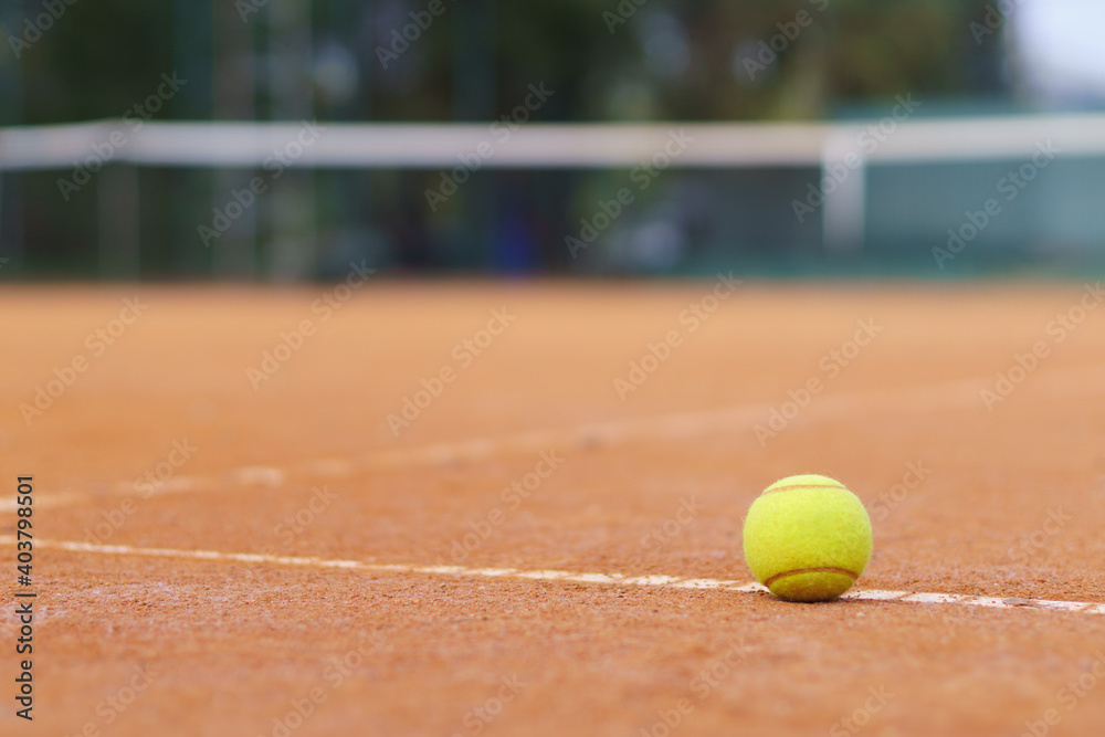 Tennis ball on a tennis court. Soft focus.