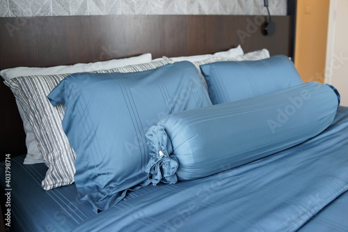 Closeup of pillows and bolster on a modern bed