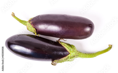 Fresh vegetable placed horizontally on a white isolated background in a photo studio - purple eggplant with a green stem from the squash family.