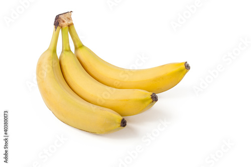 A bunch of yellow bananas three pieces on a white isolated background in a photo studio. Healthy food and vegetarianism  a healthy snack for schoolchildren.