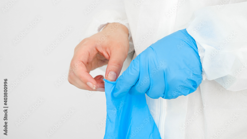 Closeup of female doctor hands wearing protective rubber gloves. Global fight and protection against covid-19 and coronavirus Closeup of female doctor hands wearing protective rubber gloves. Global fight and protection against covid-19 and coronavirus