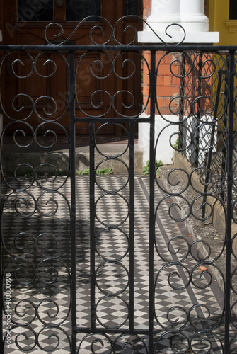 Close up detail of a wrought iron gate.