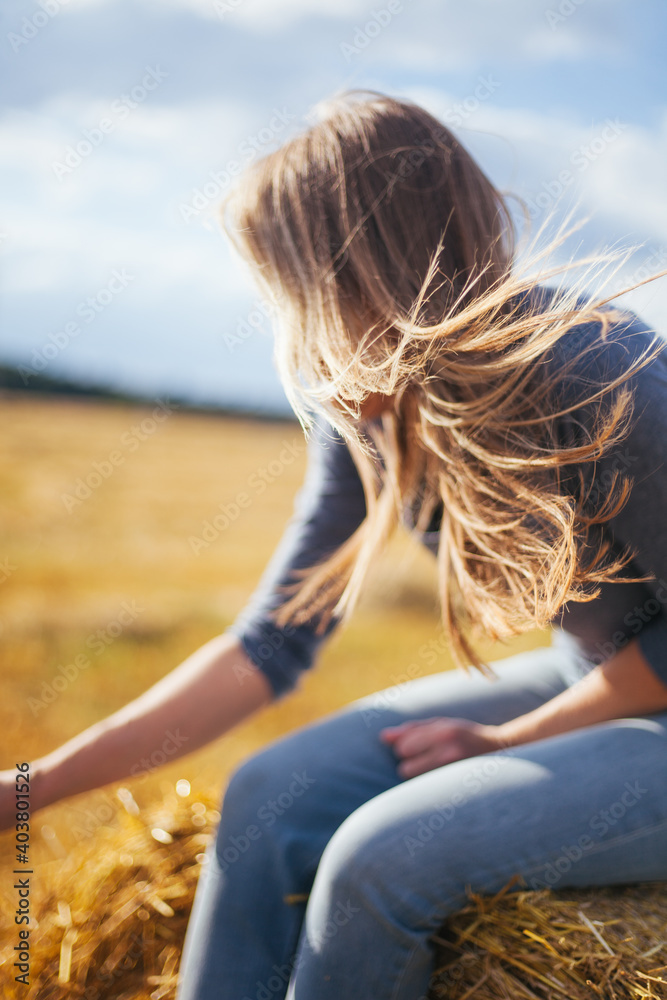 Beautiful hair fluttering in the wind. The wind blows through her blond hair.