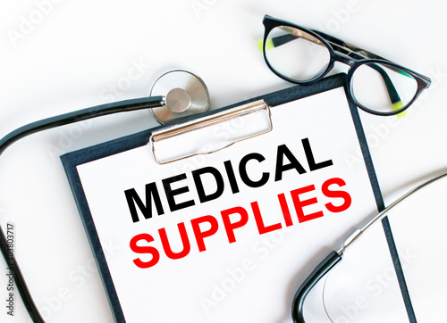 Text Medical Supplies in the folder with the stethoscope and glasses