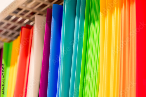 Back to school background. Rainbow colors of plastic document folders at stationery shop