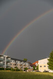 Shining Rainbow Over Residential Houses In The Country - Portrait