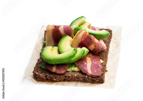 Sandwich with plant-based bacon rashers and avocado isolated on white photo