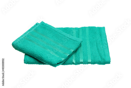 stack of green towels isolated on white.