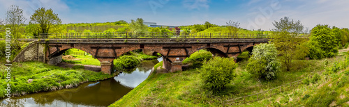 A panorama view of along Chesterfield canal towards the Manton railway viaduct and the town of Worksop in Nottinghamshire, UK in springtime