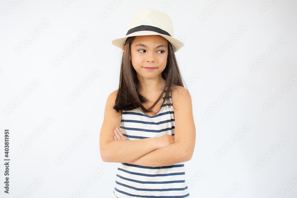 Enjoying vacation. Good vibes. Beach style. Little beauty in straw hat. Portrait of happy cheerful girl in summer hat over white background. Enjoying vacation. Good vibes. Beach style. Little beauty in straw hat. Portrait of happy cheerful girl in summer hat over white background.