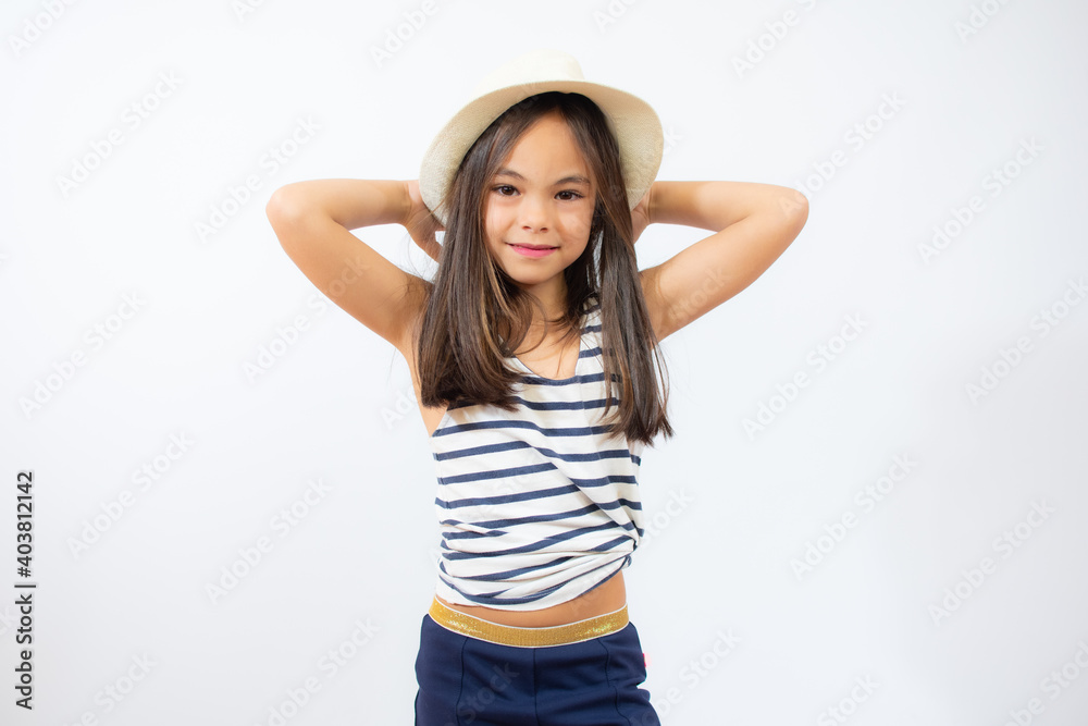 Enjoying vacation. Little beauty in straw hat. Portrait of happy cheerful girl in summer hat over white background. Enjoying vacation. Little beauty in straw hat. Portrait of happy cheerful girl in summer hat over white background.