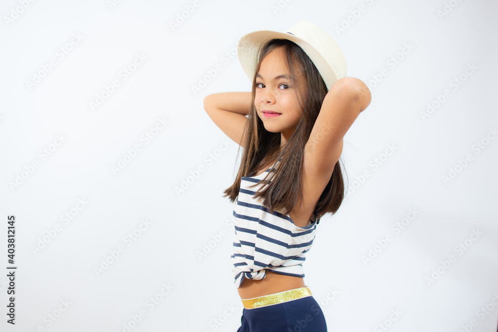 Enjoying vacation. Little beauty in straw hat. Portrait of happy cheerful girl in summer hat over white background. Enjoying vacation. Little beauty in straw hat. Portrait of happy cheerful girl in summer hat over white background.