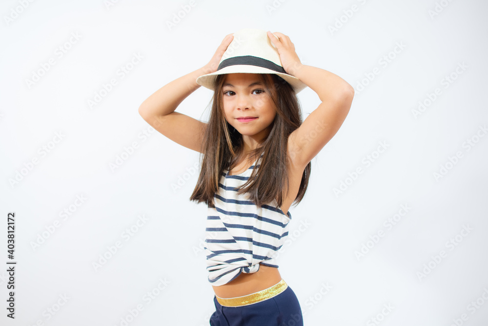 Enjoying vacation. Little beauty in straw hat. Portrait of happy cheerful girl in summer hat over white background. Enjoying vacation. Little beauty in straw hat. Portrait of happy cheerful girl in summer hat over white background.
