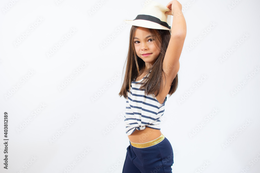Enjoying vacation. Little beauty in straw hat. Portrait of happy cheerful girl in summer hat over white background. Enjoying vacation. Little beauty in straw hat. Portrait of happy cheerful girl in summer hat over white background.