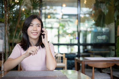 Asian women are dealing with jobs via mobile phones.