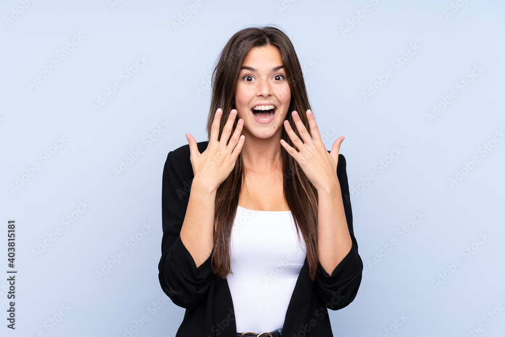 Young Brazilian business woman over isolated blue background with surprise facial expression Young Brazilian business woman over isolated blue background with surprise facial expression