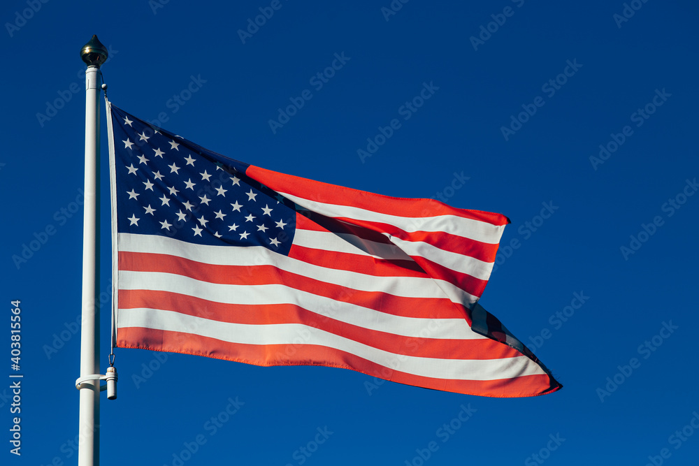 Fototapeta premium American flags against beautiful sky at sunset. Perfect background for Memorial day, Independence Day and Veterans Day. American patriotism concept. 