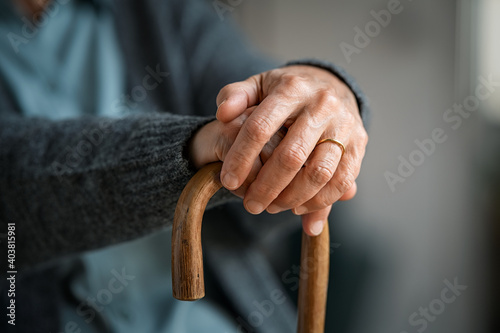 Old woman hands holding walking stick © Rido