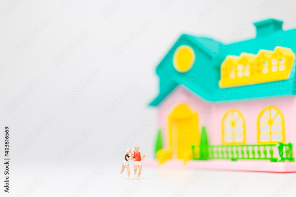 Miniature people , Couple running near their house together , Healthy lifestyle concept Miniature people , Couple running near their house together , Healthy lifestyle concept
