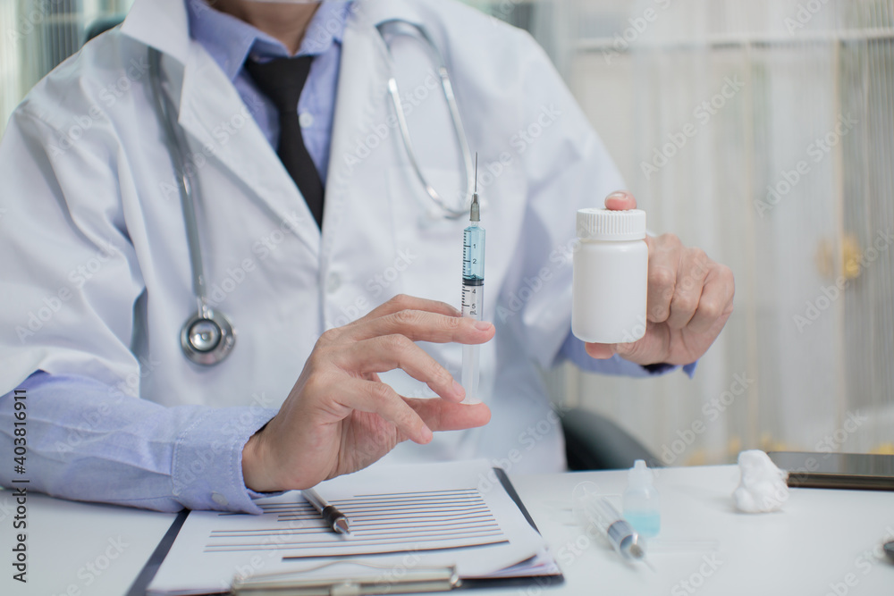 Doctor in mask taking vaccine with syringe Doctor in mask taking vaccine with syringe