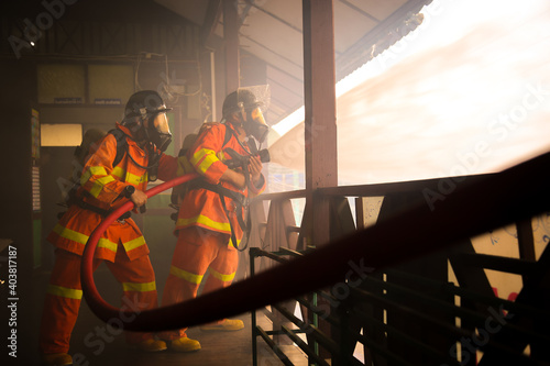 Firefighters spraying water on fire
