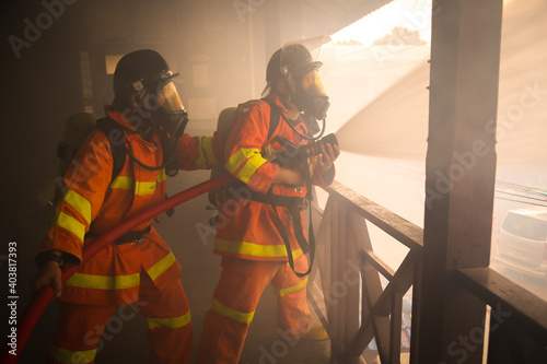 Firefighters spraying water on fire
