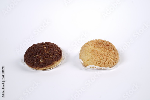 French traditional Choux pastry ball. Choux with filling chantilly cream. Fresh golden profiterole or Pate a choux. Selective focus. Cream Puffs, choco vanilla Choux isolated on white background. 