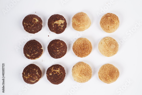 French traditional Choux pastry ball. Choux with filling chantilly cream. Fresh golden profiterole or Pate a choux. Selective focus. Cream Puffs, choco vanilla Choux isolated on white background. 