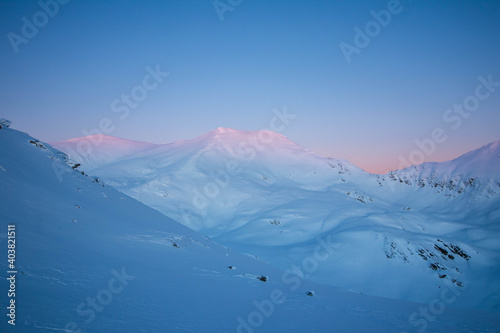 Breathtaking winter sunset landscape at high altitude with colored sky