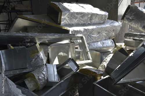 MEP works in civil construction site. Aluminum fabricated air flow duct and steel tray supporting works. ducting work. duct Insulation. HVAC system in the construction site.