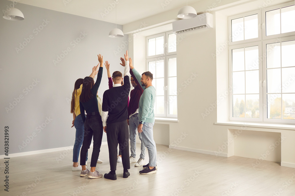 Group of happy people standing in modern office, celebrating success and high-fiving each other ready to seize new opportunity. Successful business team, teamwork, unity and collaboration concept Group of happy people standing in modern office, celebrating success and high-fiving each other ready to seize new opportunity. Successful business team, teamwork, unity and collaboration concept