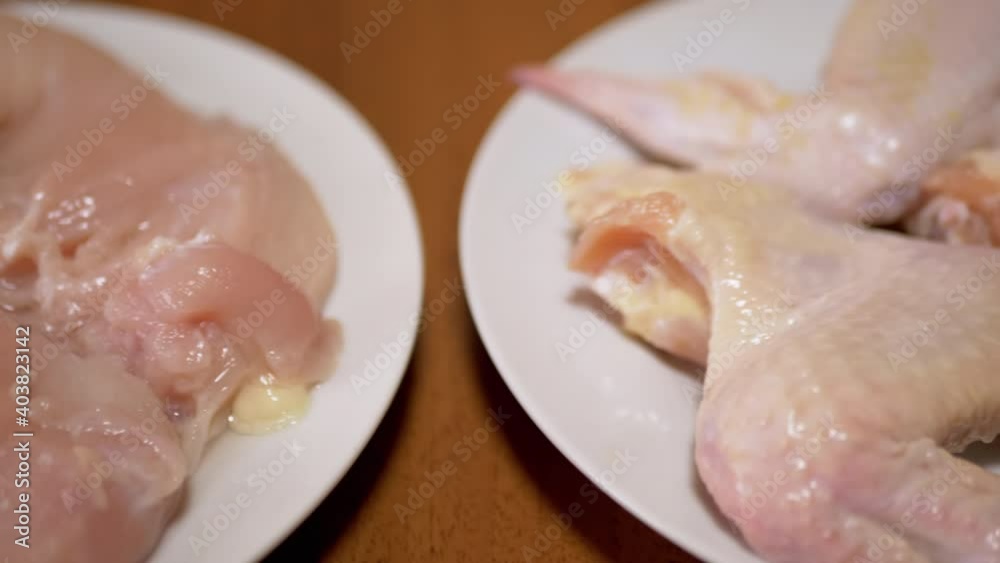 Fresh Chicken Wings, Fillets Lie On Plates. 4K. Close-up. Home Kitchen Fresh Chicken Wings, Fillets Lie On Plates. 4K. Close-up. Home Kitchen