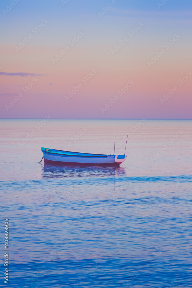 boat on calm ocean at sunset, background