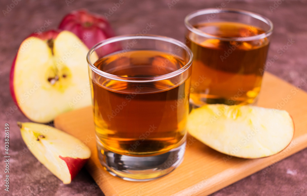 Two glasses of apple juice.
Close-up.
Two glasses of apple juice.
Close-up.