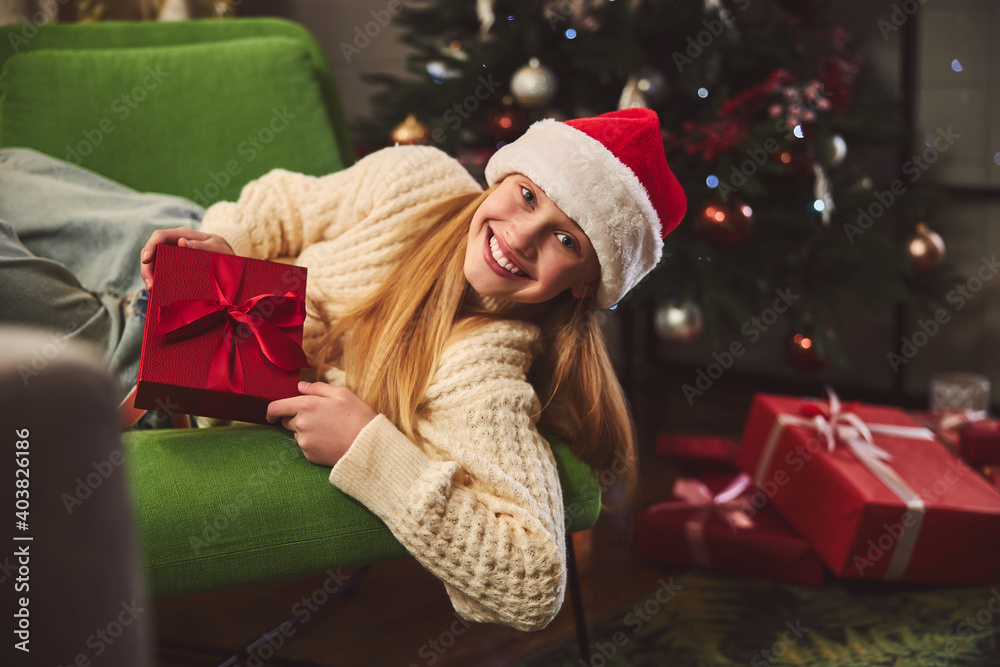 Smiling girl spending happy Boxing Day at home Smiling girl spending happy Boxing Day at home