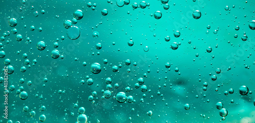 oil drops on water on blue background