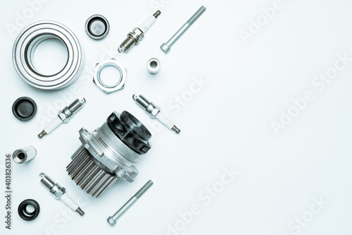 Car service. Auto motor mechanic spare or automotive piece on white background. Set of new metal car part. Repair and vehicle service with space for text.
