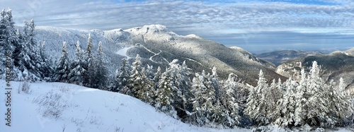 Panoramic mountain view of beautiful mountain peaks at snow day on the top of Stowe Mountain Ski resort, Vermont - December 2020