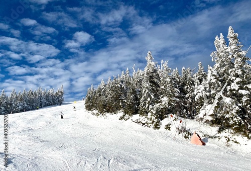 Beautiful sunny snow day with blue sky and clouds at the Stowe Mountain Ski resort Vermont - December 2020