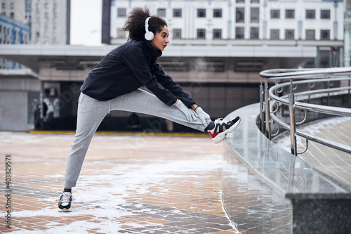 Enthusiastic lady is feeling her ankle outside