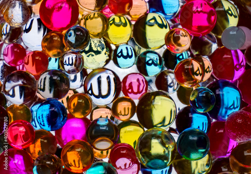 Colorful glass balls with Allah names reflection. Perfect for background islamic concept. 