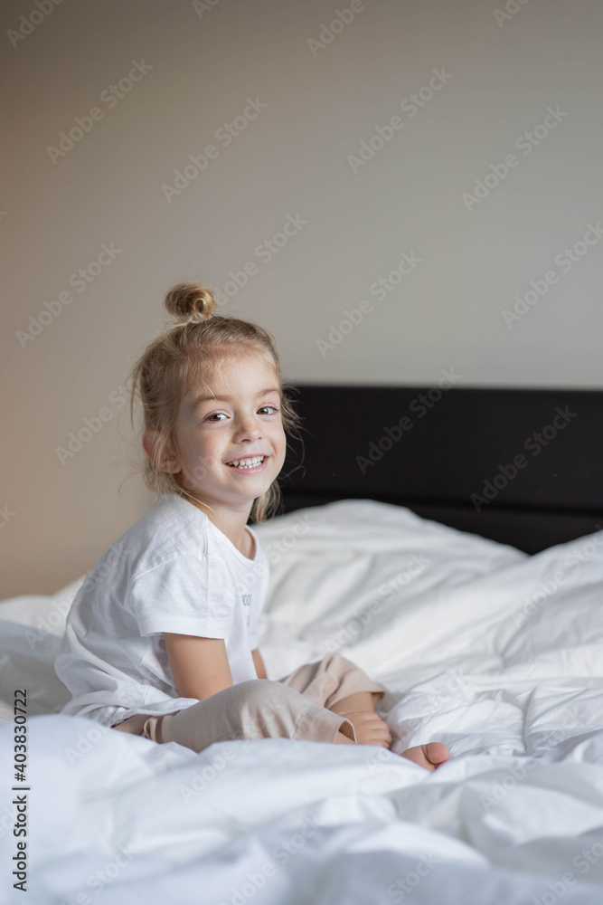 Little girl have fun on bed. smiling and playing with blanket. Little girl have fun on bed. smiling and playing with blanket.